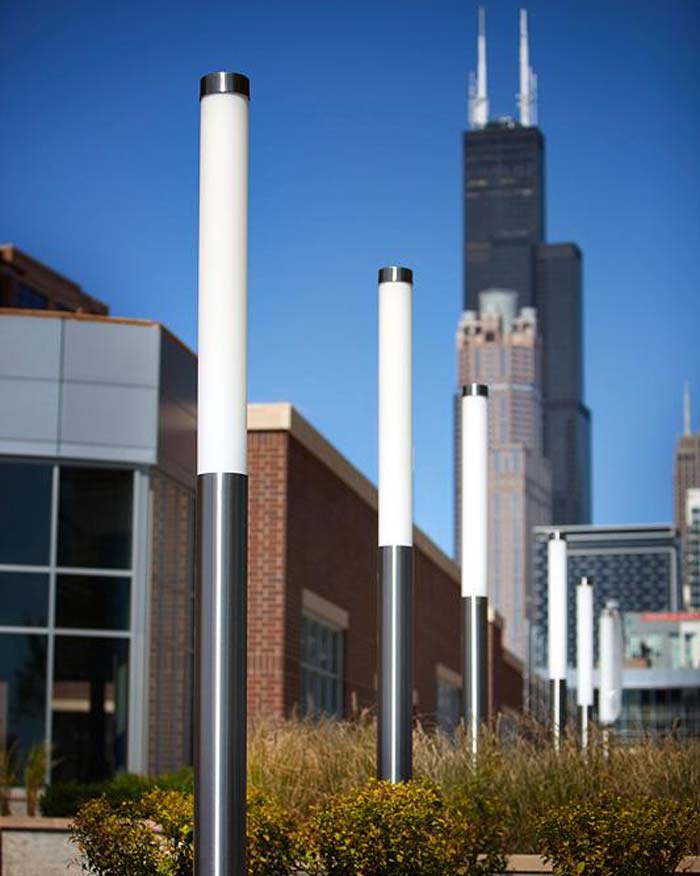 led pole lights align on city sidewalk
